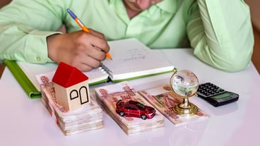 The concept of family budget planning, dividing income for the purchase of a house, car and travel