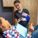 In dentistry Darkskinned boy looking interested in jaw mockup