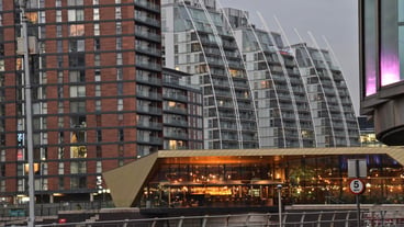 Low angle view of modern buildings in city at dusk