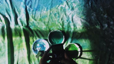 Cropped image of a person taking a picture via a mobile phone