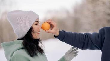 Happy couple playing winter game in forest outdoors girlfriend with boyfriend funny