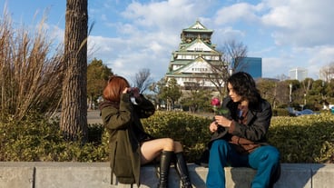 Side view of girlfriend taking boyfriend's picture on White Day