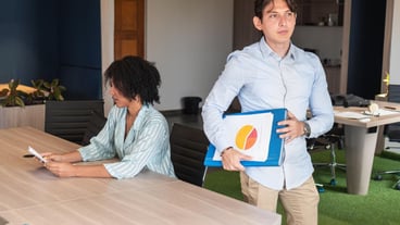 Businessman holding charts leaving meeting with manager reading documents