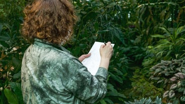 Middle-aged woman drawing nature, green leaves from nature. Painting.