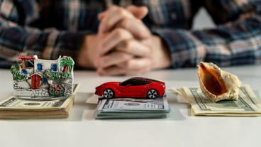 Us dollar banknotes.money for new purchases. saving money for car, house, travels. savings concept. A small house, car and shell lies on a table of thousand dollars thousand dollars.High quality photo