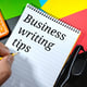 Word BUSINESS WRITTING TIPS on notebook with hand holding pencilBusiness concept