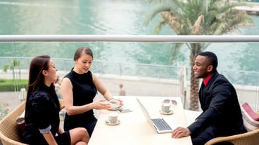Side shot of elegant people having discussion at cafe.