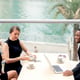 Side shot of elegant people having discussion at cafe.