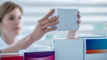 Close up of a pharmacist putting a medicine on the shelf