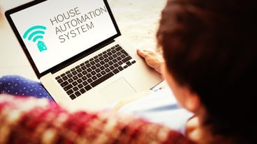 Pregnant woman using her laptop against home automation system