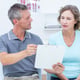 Physiotherapist showing his notes to his patient