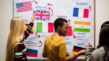 High school students work aboard international flags