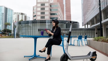 Young adult traveling using sustainable mobility