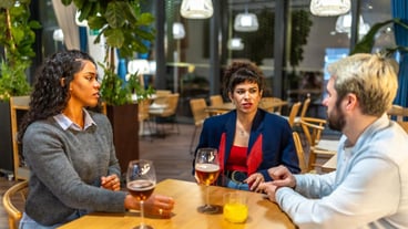 Coworkers enjoying beer together after work outside a bar