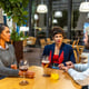 Coworkers enjoying beer together after work outside a bar