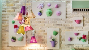 Many pendant lights on a brick wall with decorative panels