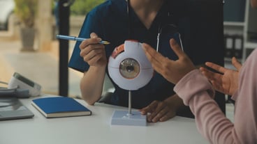 Ophthalmologist doctor in clinic part of eye model on desk oculus sample