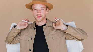 Man with brown hat and shopping bags
