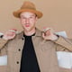 Man with brown hat and shopping bags