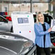 Saleswoman showing infographic during presentation about automotive suspension performance in car dealership