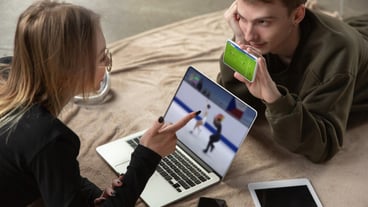 Couples with laptop and phone watching sports, football online streaming championship. New rules during coronavirus outbreak and country lockdowns. The concept of sports, competition, technologies.