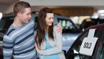 Couple looking to a new car