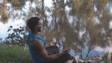 The young man have a meditation by the river