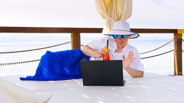 Rear view of woman using laptop on table
