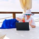 Rear view of woman using laptop on table