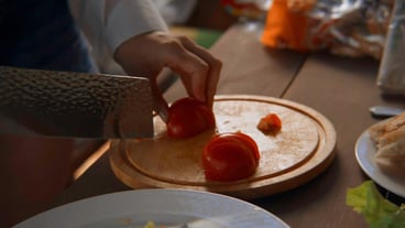 Closeup of chef slicing tomatoes on board stock footage beautiful culinary slicing of vegetables for