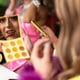 Side view of a drag queen applying makeup