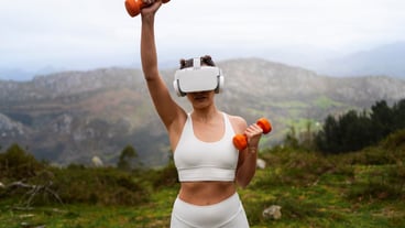 Woman using vr glasses to exercise outdoors with weights