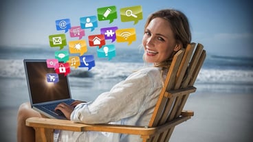 Composite image of the beautiful blonde sitting on a chaise longue using a laptop on the 3d beach