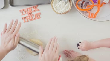 Step by step. Mother and daughter maaking Halloween sugar cookies.