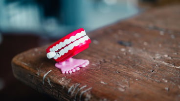Close-up of a red denture on the table