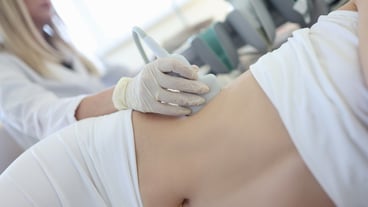 The doctor performs an ultrasound examination of the patient's kidneys