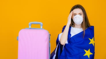Beautiful girl in a white summer dress with a suitcase Medical mask on the face Closed borders
