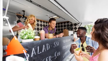 happy customers buying burger at food truck