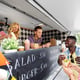 happy customers buying burger at food truck