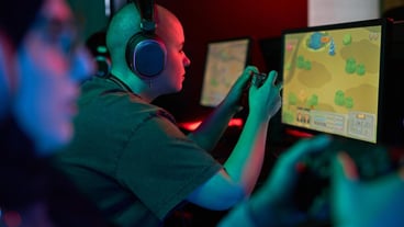 Woman holding gaming controller and playing video games