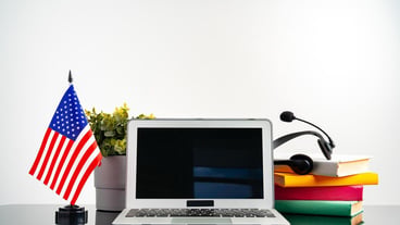 Online education concept with usa flag next to a laptop