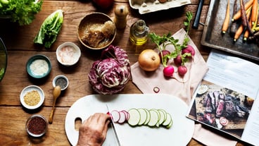 Hands using knife chopping a zucchini