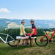 Couple sportsman near bicycles in mountains