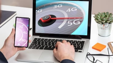 5G High speed network connection speedometer on a computer laptop screen business office background