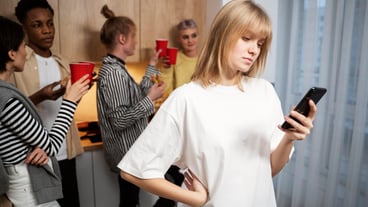 Medium shot woman sitting alone with phone