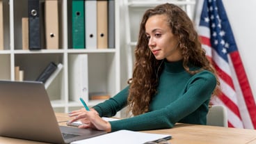 Medium shot girl with headphones and laptop indoors