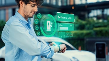 Businessman checking EV car battery status in hologram from smartwactch Peruse