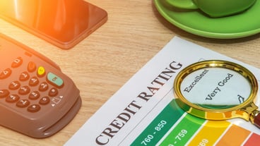 Credit rating form on office desk with magnifying glass