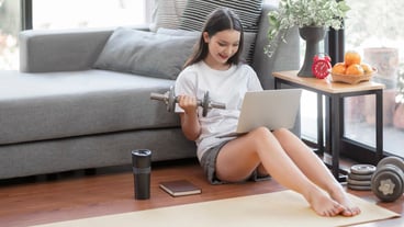Young woman stay at home and learning online workout at home.