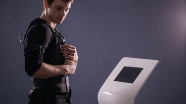 Man standing near an EMS machine